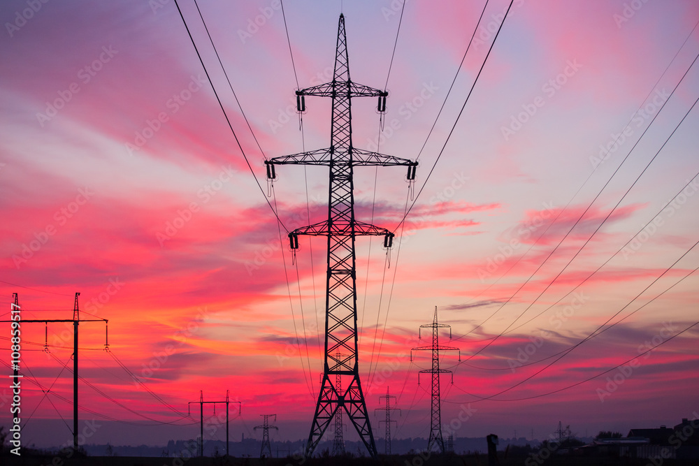 High voltage electricity pylon system on sunrise background