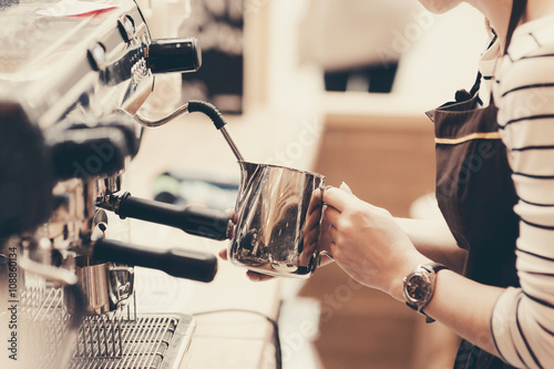 Barista preparing coffee in a cafe. Professional coffee brewing, service and catering concept