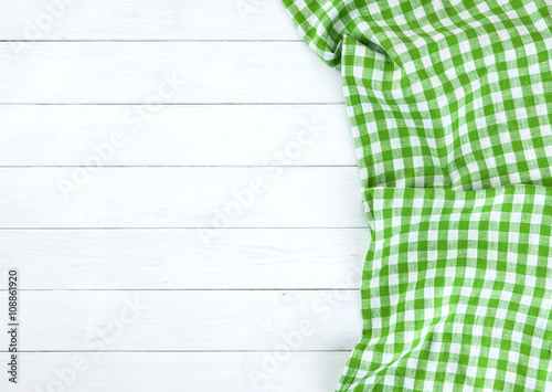 Green tablecloth on white wood table