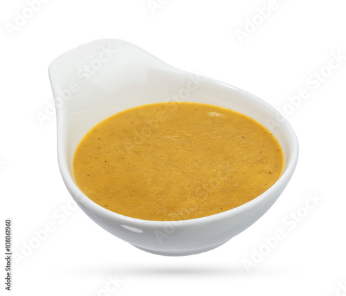 Mustard in bowl isolated on white background.