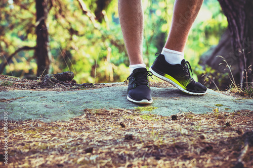 Young male cross country runner, legs and shoes detail