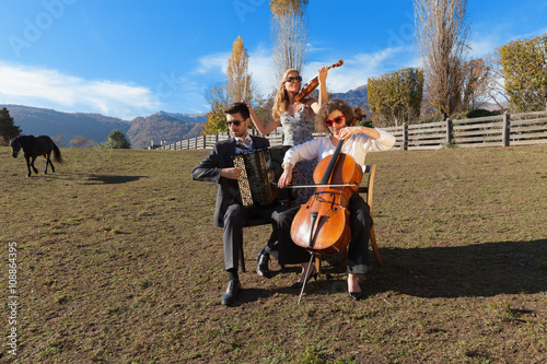 three young musicians, outdoors