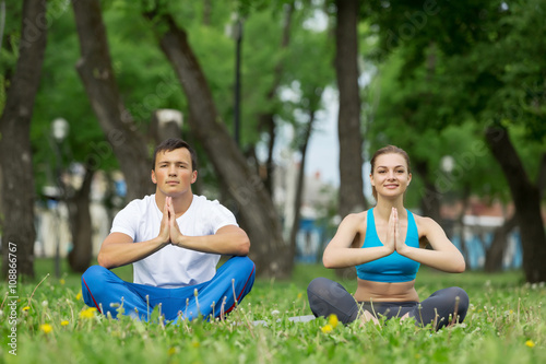Having yoga practice in park © Sergey Nivens