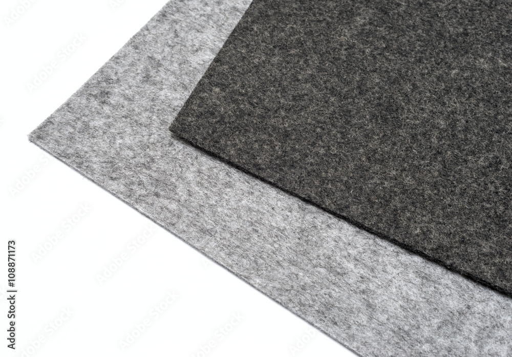 Fototapeta premium gray felt pieces on a white background.