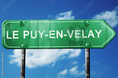 le puy-en-velay road sign, vintage green with clouds background