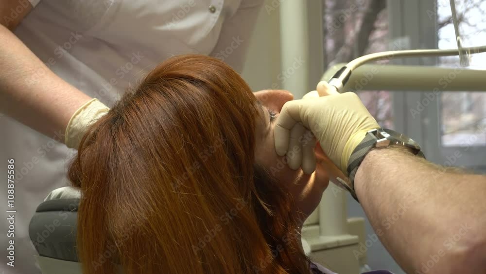 Young Woman in a Chair Dentist Dentistry Procedure, Doctor and Nurse at Work Young Woman in a Chair Dentist Dentistry Procedure, Doctor and Nurse at Work