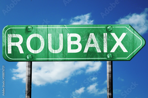 roubaix road sign, vintage green with clouds background photo