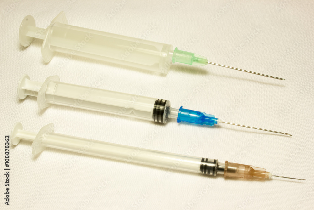 Plastic disposable syringe on white background. Plastic disposable syringe on white background.