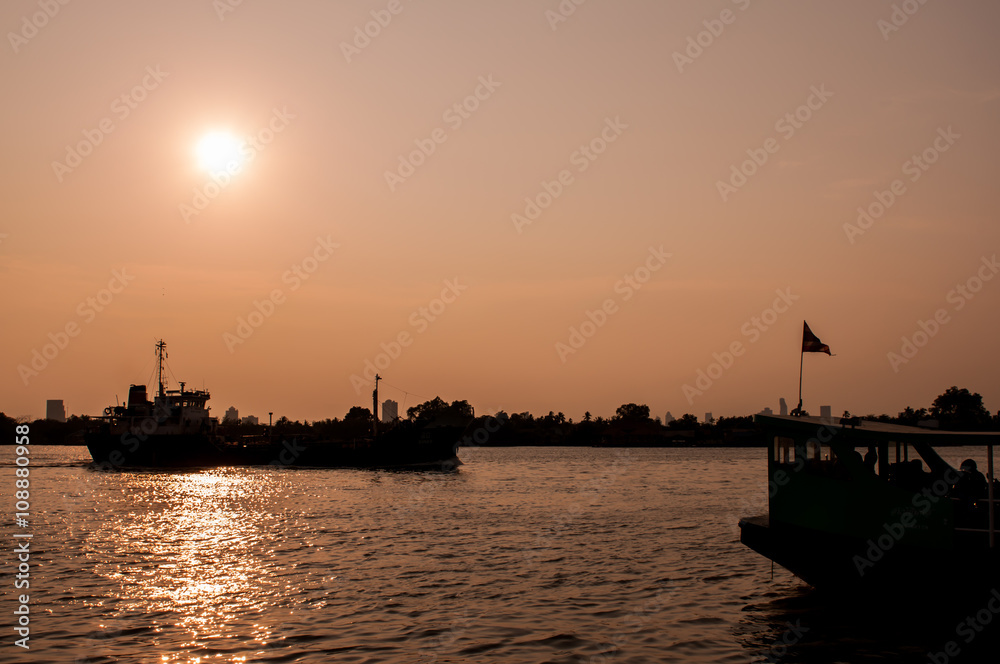 Silhouette,blurry boat on the river at sunset.art tone background.