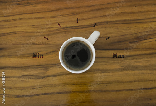 Cup of coffee and gage volume concept on wooden table