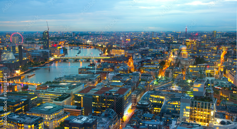 London at sunset.  River Thames, bridges and night lights City of London