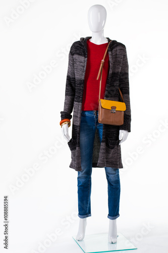 Sweater coat and bicolor purse. Mannequin in outerwear with bag. Brown and yellow leather handbag. Accessory choice for autumn outfit. © DenisProduction.com