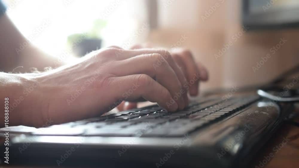 Man hands touch typing quickly on black keyboard