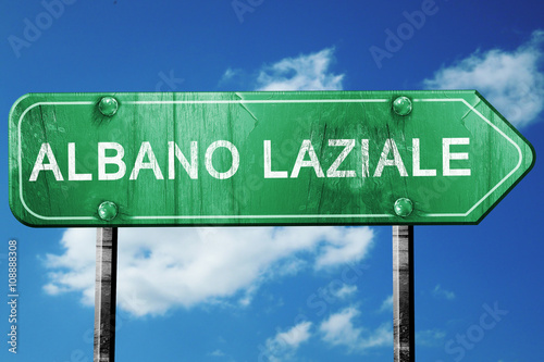 Albano laziale road sign, vintage green with clouds background