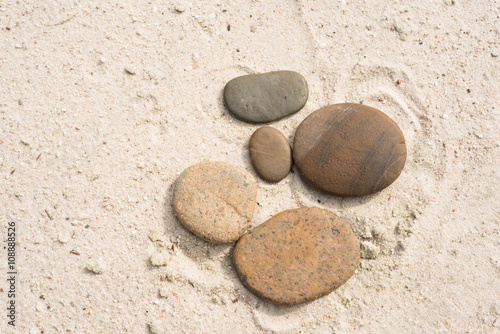 Photography five zen stones with copy space lying on the beach
