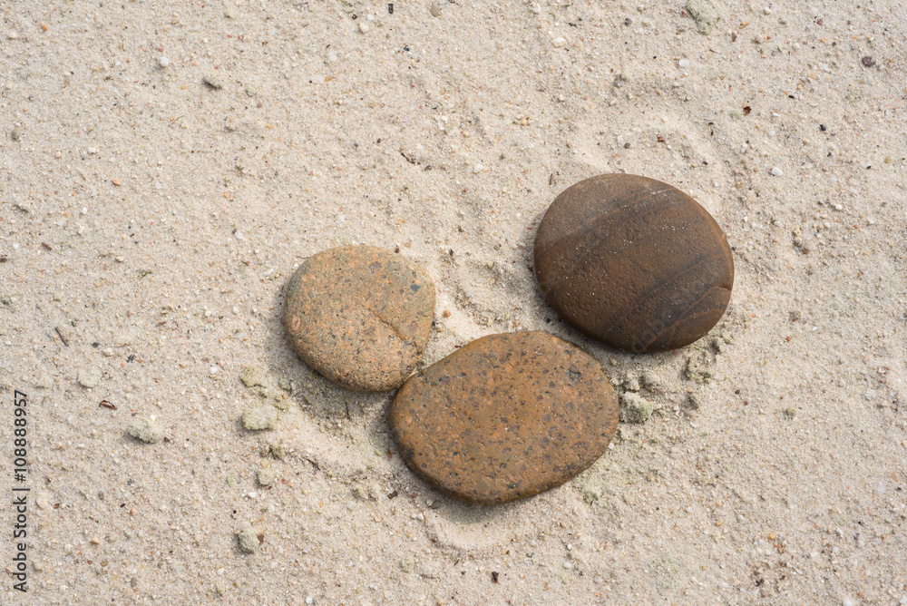 three zen stones with copy space lying on the beach three zen stones with copy space lying on the beach