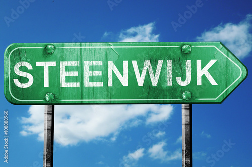 Steenwijk road sign, vintage green with clouds background