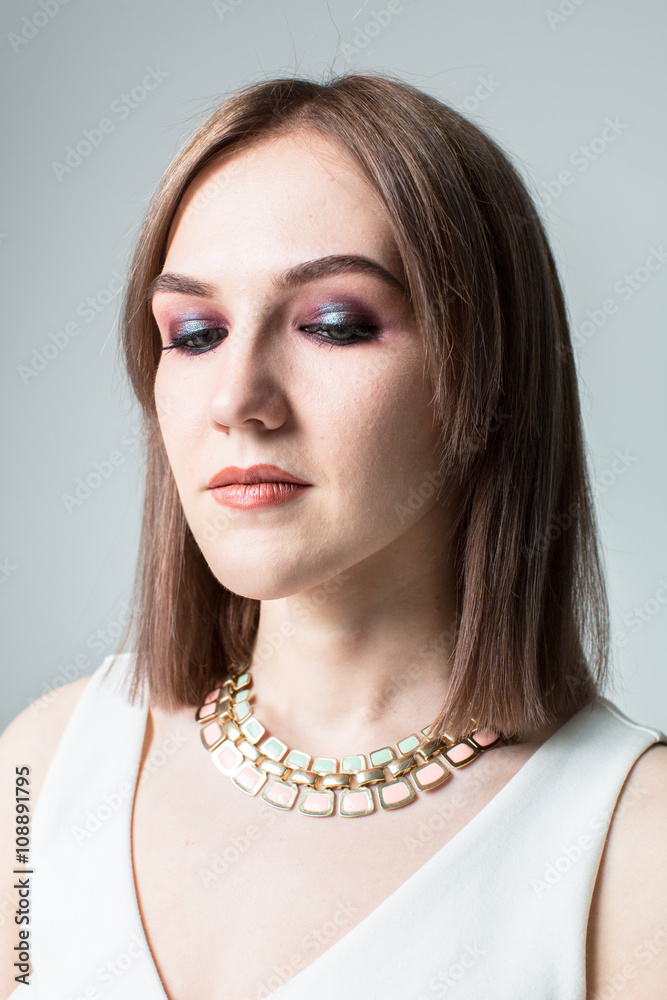 Portrait of young beautiful woman with middle length hair and smoky eyes make-up