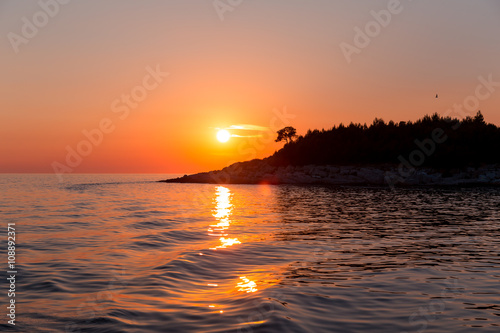 Sea sunset with ship trace