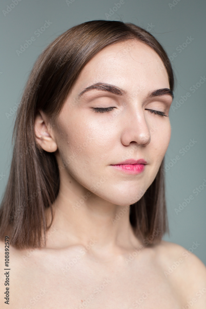 Beauty portrait of young model with middle length hair. Professional nude makeup. Green eyes.
