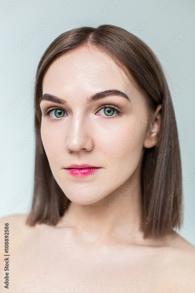 Beauty portrait of young model with middle length hair. Professional nude makeup. Green eyes.