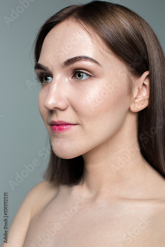Beauty portrait of young model with middle length hair. Professional nude makeup. Green eyes.