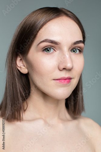 Beauty portrait of young model with middle length hair. Professional nude makeup. Green eyes.