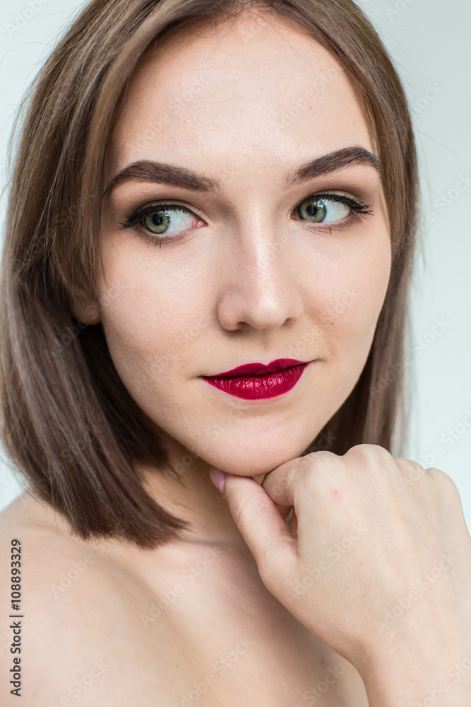 Portrait of gorgeous young caucasian attractive sexy woman with business makeup. Red lips and green eyes Portrait of gorgeous young caucasian attractive sexy woman with business makeup. Red lips and green eyes