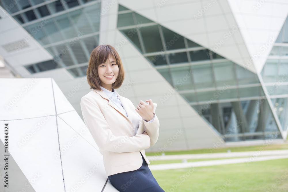 Fototapeta premium Attractive asian business woman working on tablet computer outsi
