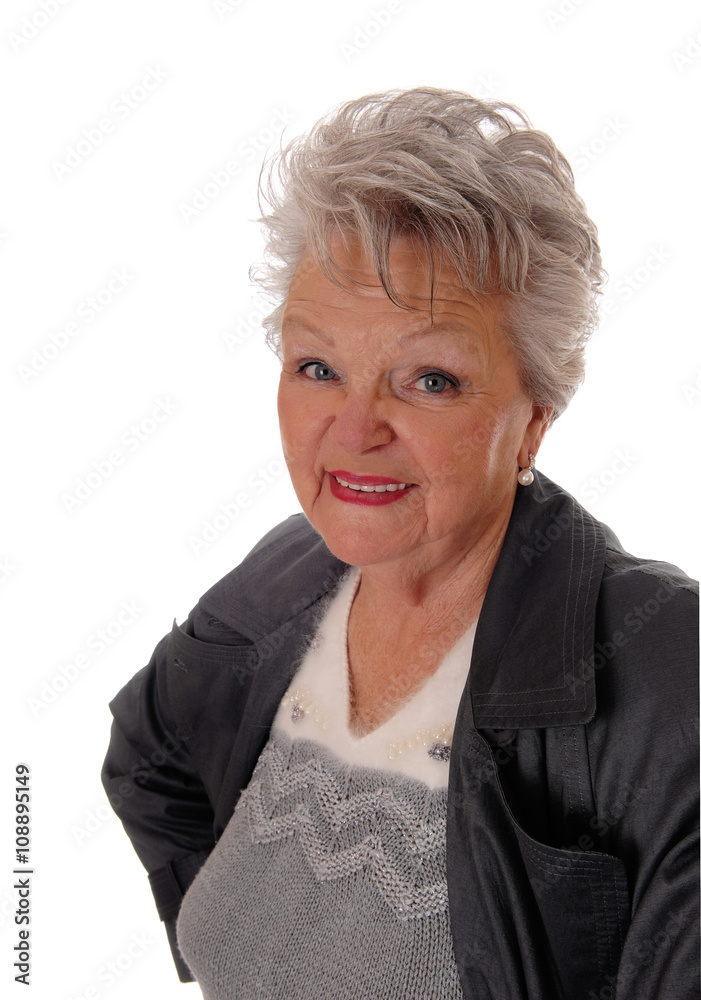 Closeup of senior woman standing in a coat. Closeup of senior woman standing in a coat.