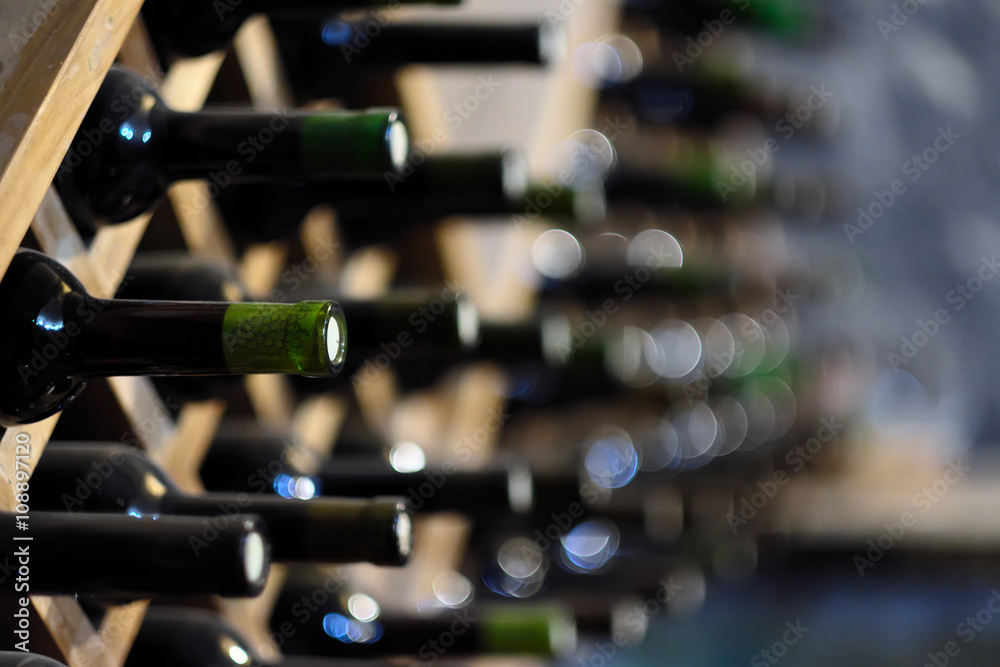 Wine bottles stacked on wooden racks