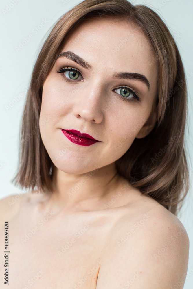 Portrait of gorgeous young caucasian attractive sexy woman with business makeup. Red lips and green eyes Portrait of gorgeous young caucasian attractive sexy woman with business makeup. Red lips and green eyes