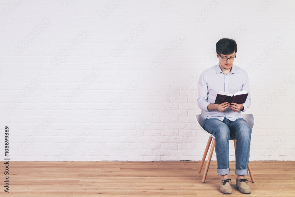 Caucasian man reading book interior Caucasian man reading book interior