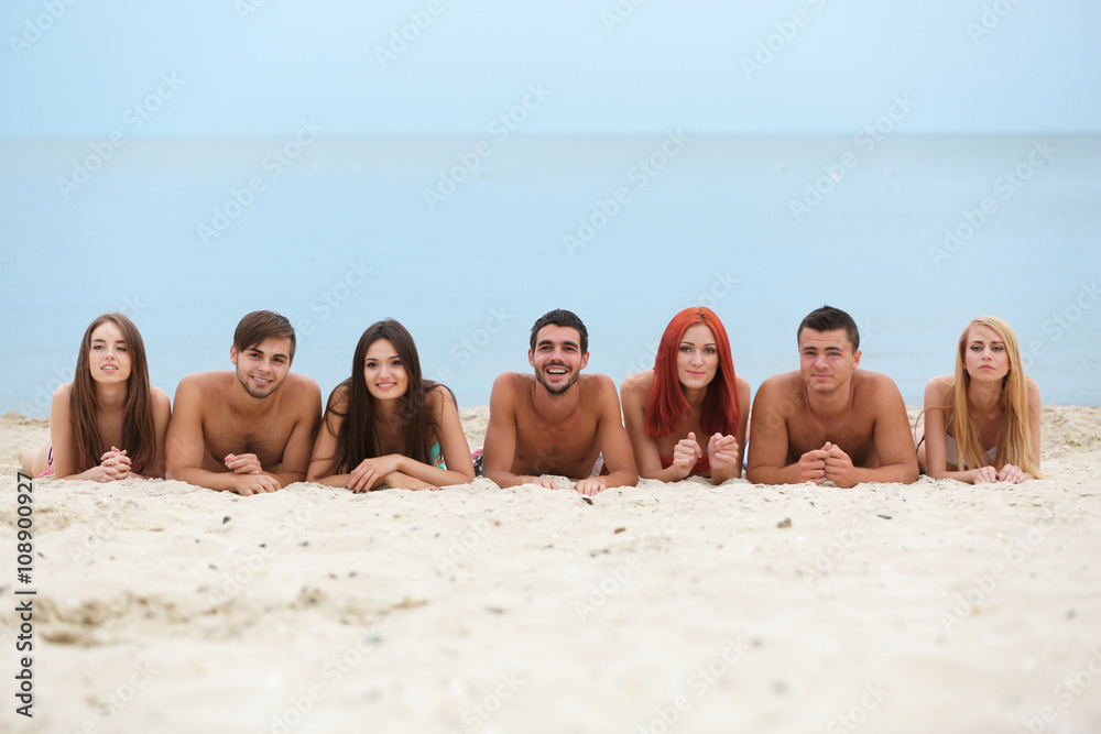 Beautiful young people lying on beach Beautiful young people lying on beach