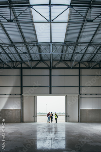 Photos Architect team At Work Site With Blueprints
