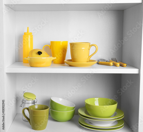 Tableware on shelves in the kitchen cupboard
