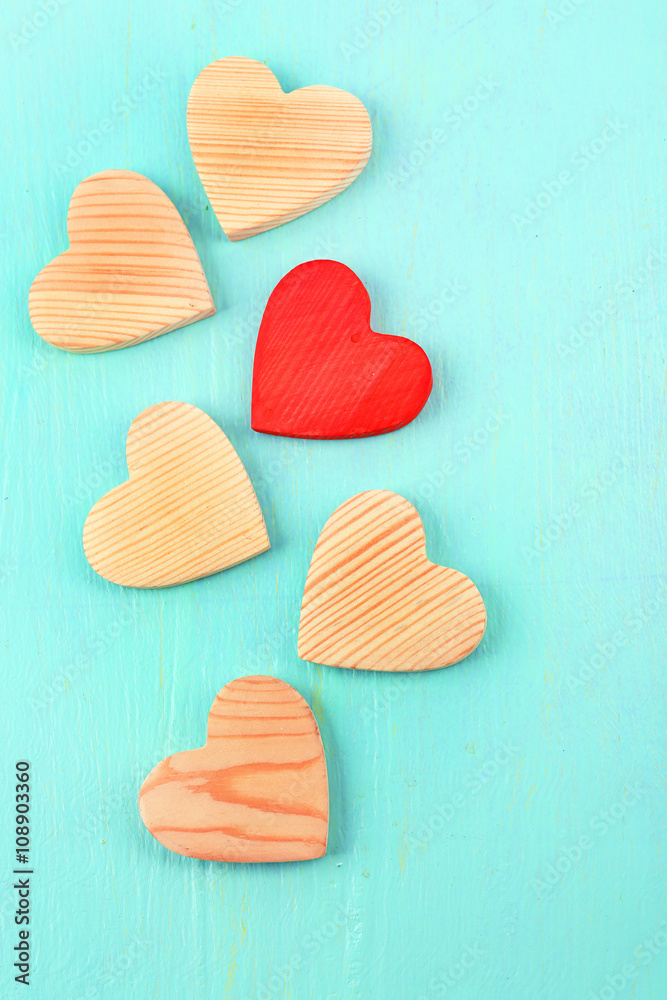Fototapeta premium Wooden hearts on color wooden background