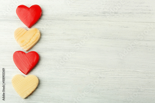 Wooden hearts on light background