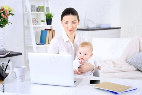 Businesswoman with baby boy...
