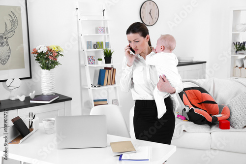 Businesswoman with baby boy...
