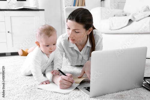 Businesswoman with baby boy...