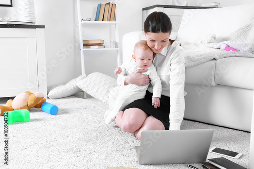 Businesswoman with baby boy...