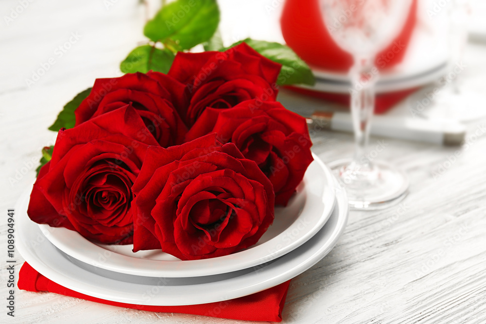 Red roses on holiday served table Red roses on holiday served table