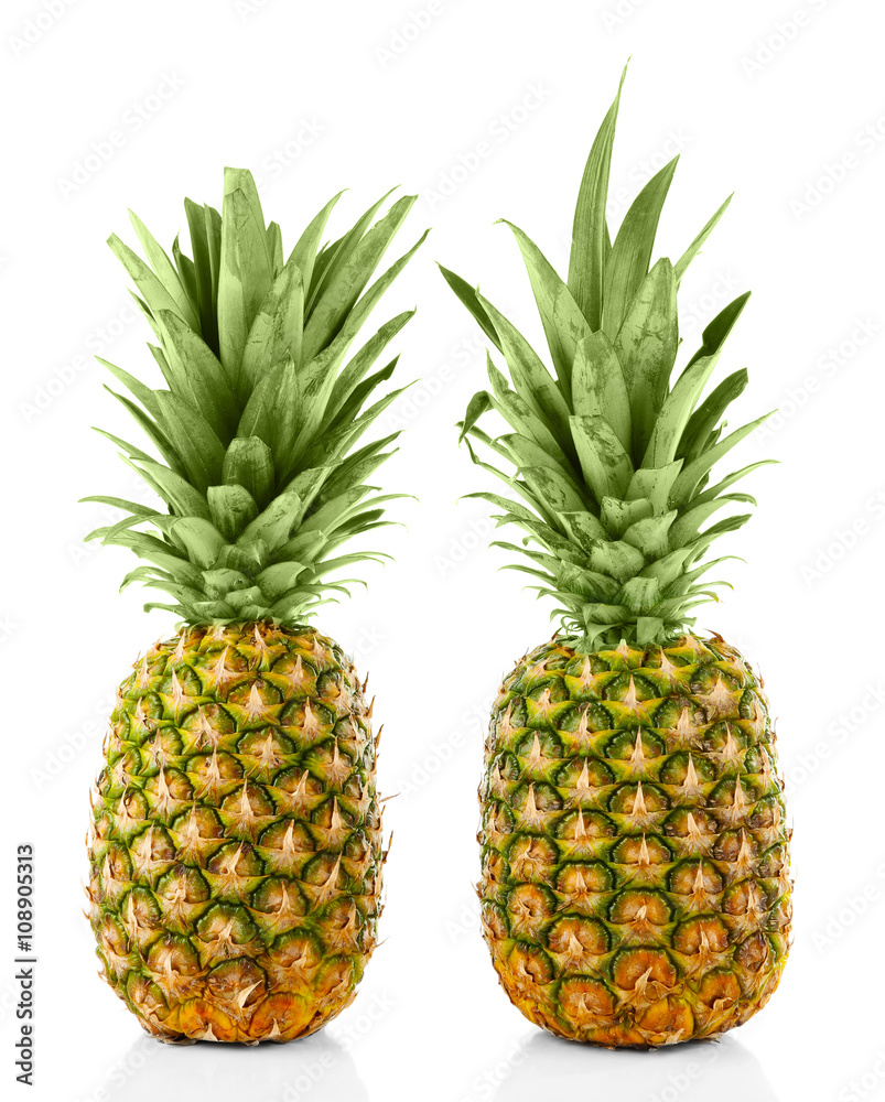 Two ripe fresh pineapples, isolated on white