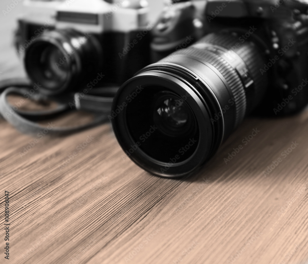 New and old cameras on wooden floor