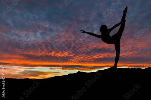 Silhouette of Woman Dancing Outdoors at Sunset © ronniechua