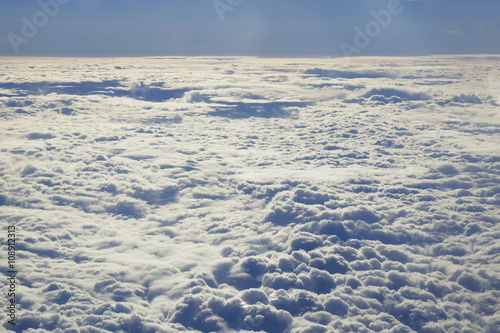 Clouds and sky as seen through window of an aircraft