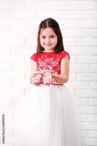 Little girl in dress on a w...