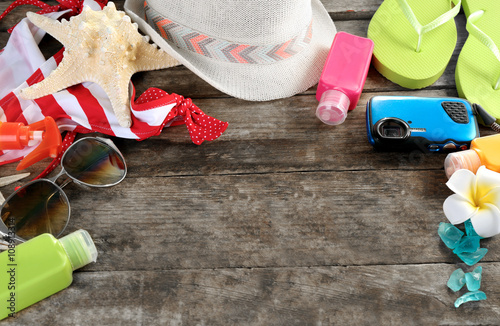 Summer accessories on wooden table, close up