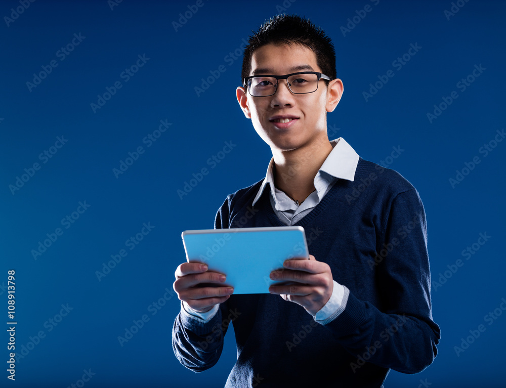 chinese guy smiling holding an ipad chinese guy smiling holding an ipad